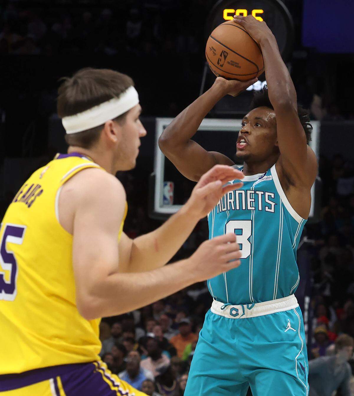 Charlotte Hornets guard Collin Sexton, right, releases a jump shot as Los Angeles Lakers guard Austin Reaves, left, defends during action on Monday, November 10, 2025 at Spectrum Center in Charlotte, NC. The Lakers defeated the Hornets 121-111.