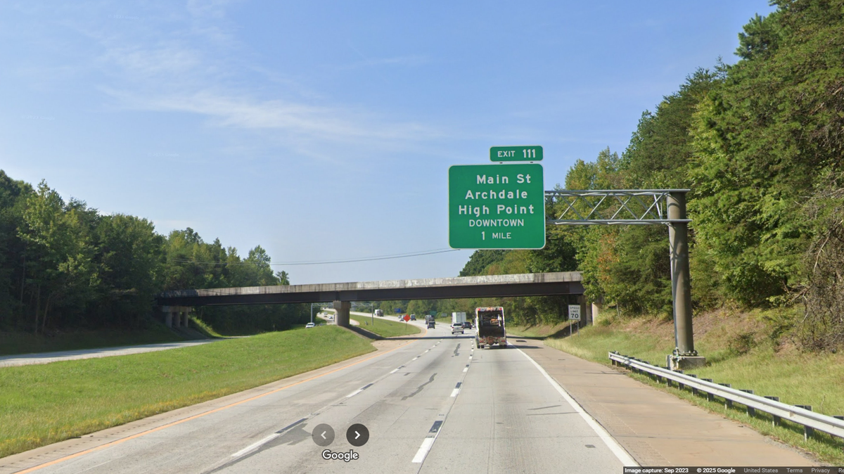 The troopers stopped a vehicle near mile marker 118 on Interstate 85 south, and discovered a woman under attack from a passenger, the N.C. Highway Patrol said.