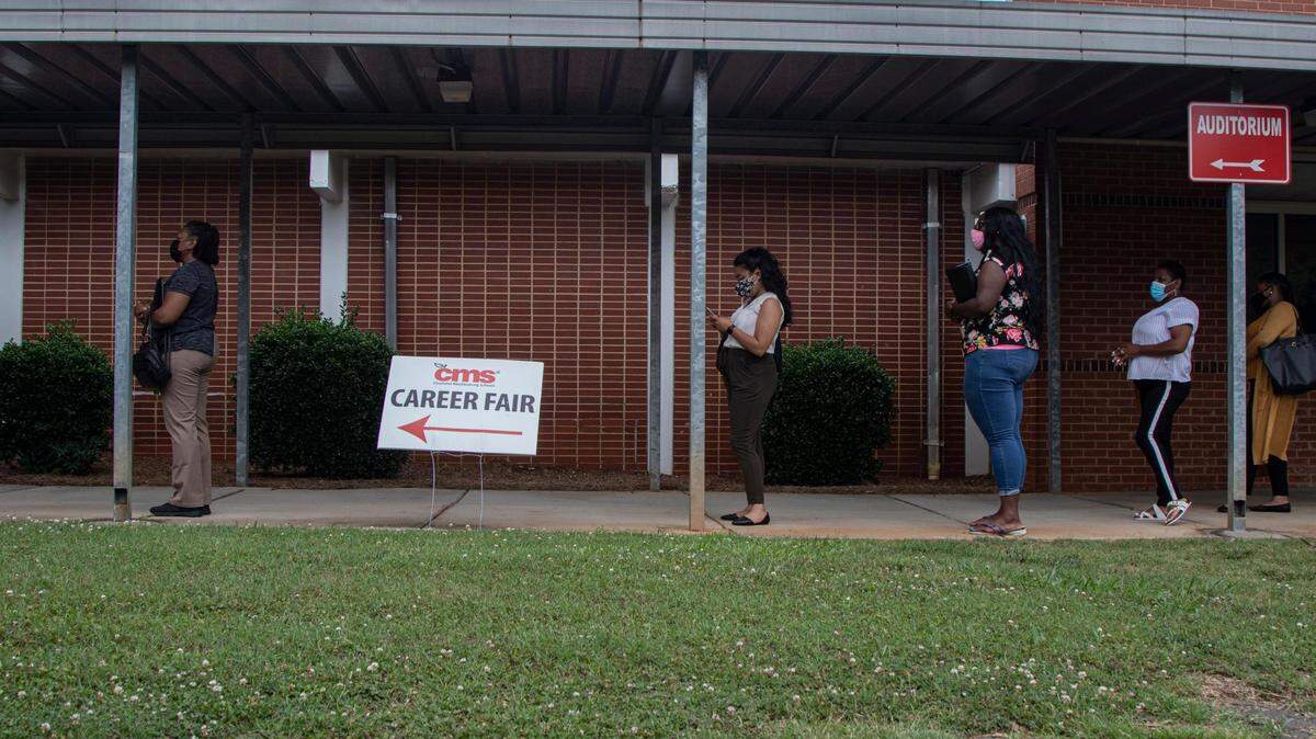 Teachers arrive at the Spaugh Administrative Center for a job fair hosted by Camp Charlotte-Mecklenburg Schools on Wednesday, June 9, 2021.
