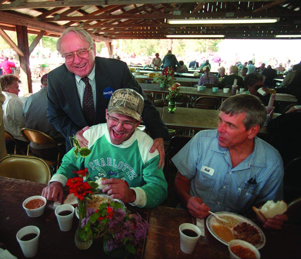 U.S. Sen. Lauch Faircloth jokes with Bob Hardman as Neil Maelker looks on at the Mallard Creek Barbecue in 1998.