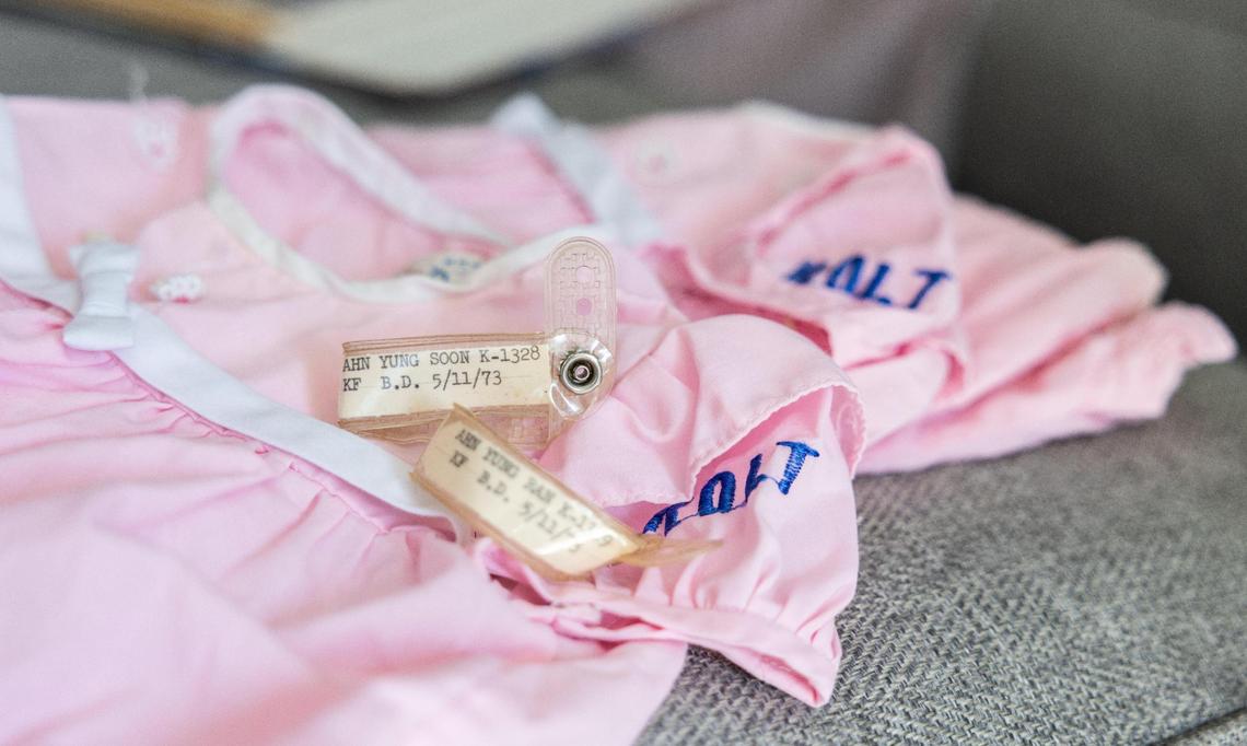 The dresses and identification bracelets that Dee and Becca were wearing when they arrived in the United States in 1973.