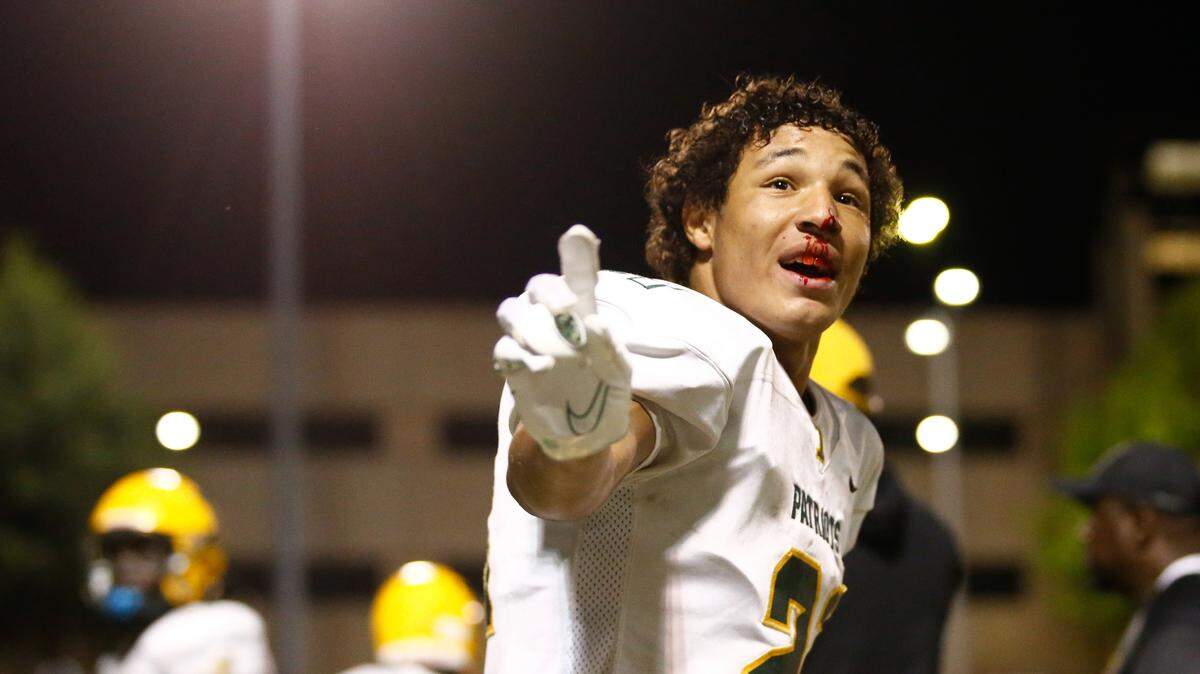 Independence sophomore Jayden Jones (21) points to the crowd with a bloody nose after a face mask penalty was called against Charlotte Catholic during the third quarter at Charlotte Catholic High School on September 22, 2023.