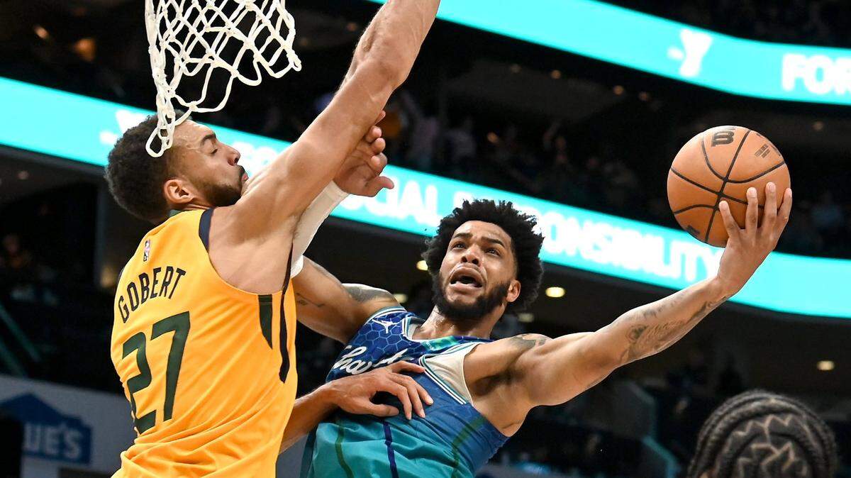 Charlotte Hornets forward Miles Bridges, center, drives into the lane for a shot against Utah Jazz center Rudy Gobert, left, at Spectrum Center in Charlotte in March. The Hornets trading their draft picks for Gobert could give them a much-needed roster piece in the post.