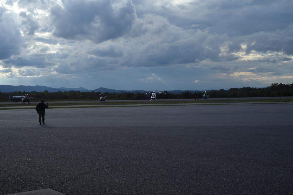 Helicopters owned by volunteer pilots with Operation Airdrop wait at the Hickory Regional Airport on Monday, Sept. 30, 2004, for pilots to fly supplies to people cut off by Helene’s flooding in western North Carolina.