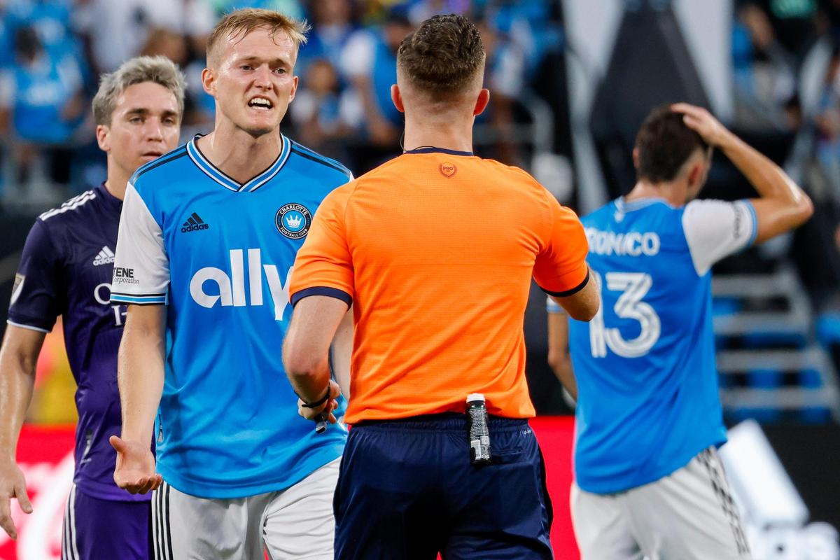 Charlotte FC forward Karol Swiderski argues with official Lukasz Szpala during the first half against Orlando City in Charlotte, N.C., Sunday, Aug. 21, 2022.