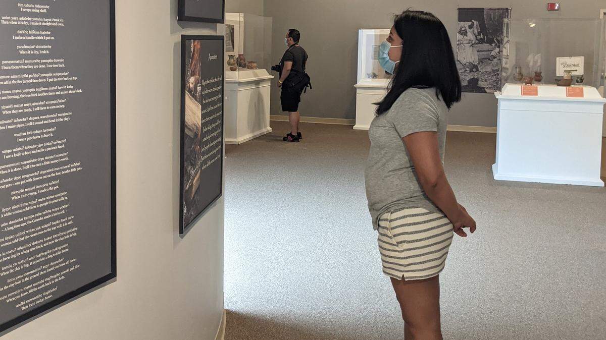 A visitor views the Catawba Pottery exhibit at the Charlotte Museum of History.