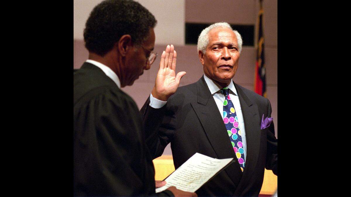 Charlie Dannelly (right) is sworn in Thursday as senator for N.C. State Senate District 33 by Clifton Johnson, senior associate judge of the N.C. Court of Appeals in 1994. The ceremony was held at the Charlotte-Mecklenburg Government Center. 