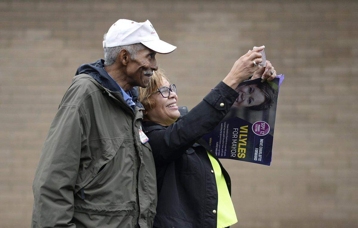 Wilbert Russell, 71, traveled from his home in Alabama by train, to help his son Will Russell campaign for Charlotte City Council, District 4. Vi Lyles, candidate for Charlotte mayor, takes a selfie with Russell at the Oasis Shriner's Temple Tuesday morning. Charlotte's mayoral race has been a hot one for Democrats. Vi Lyles and Joel Ford are both hoping to unseat Mayor Jennifer Roberts in this primary election. Lyles and Ford campaigned on Tuesday Sept, 10, 2017.