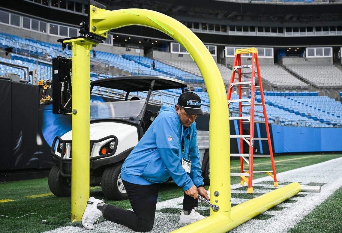 A worker dismantles one of the goal posts a few minutes after the end of the Panthers' home game against the Bills at Bank of America Stadium on Sunday, October 26, 2025. Stadium operations crew work diligently to start transitioing the field from an NFL game and prepping it for an MLS game at Bank of America Stadium in Charlotte, NC on Sunday, October 26, 2025.