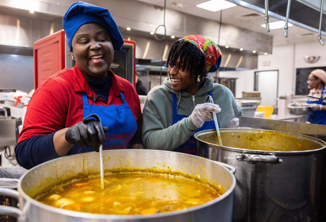 Owner of Ms. Didi’s, Edith Jean-Francois and her daughter, Christina Bowman, stir pots of soup joumou in Charlotte on Tuesday, Dec. 31, 2024.