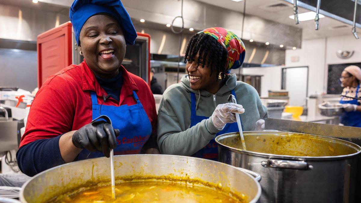 Owner of Ms. Didi’s, Edith Jean-Francois and her daughter, Christina Bowman, stir pots of soup joumou. In April, they opened a brick-and-mortar location.