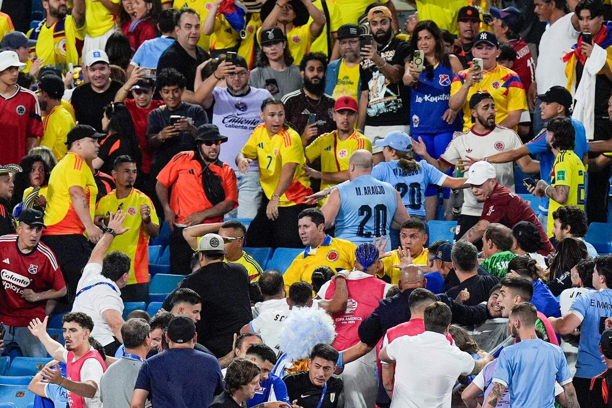 Fans get into an altercation with players and staff from Uruguay after Wednesday’s Copa Armerica semifinal match between Uruguay and Colombia at Bank of America Stadium.