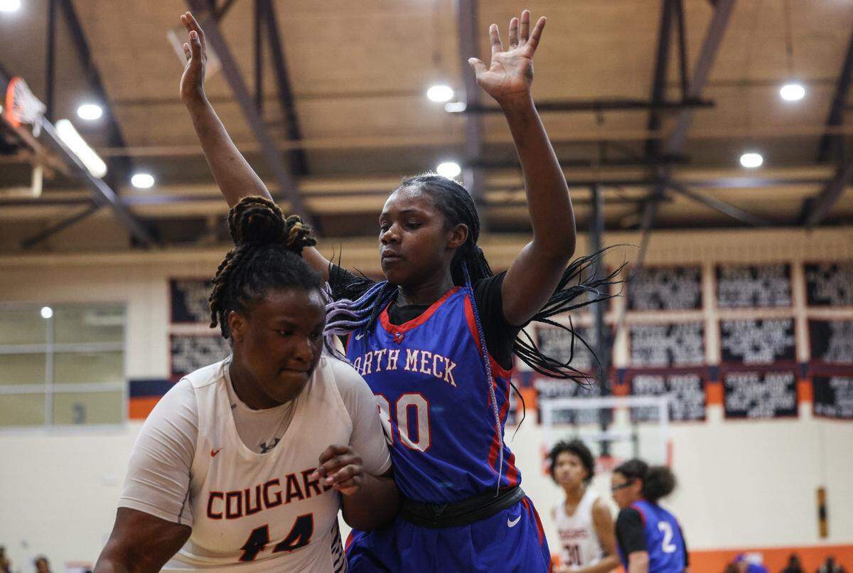 Chambers’ Taneese Bridges, left, tries to drive to the basket as North Meck’s Lenise Joseph defends during the game at Chambers High School on Thursday, January 9, 2025.