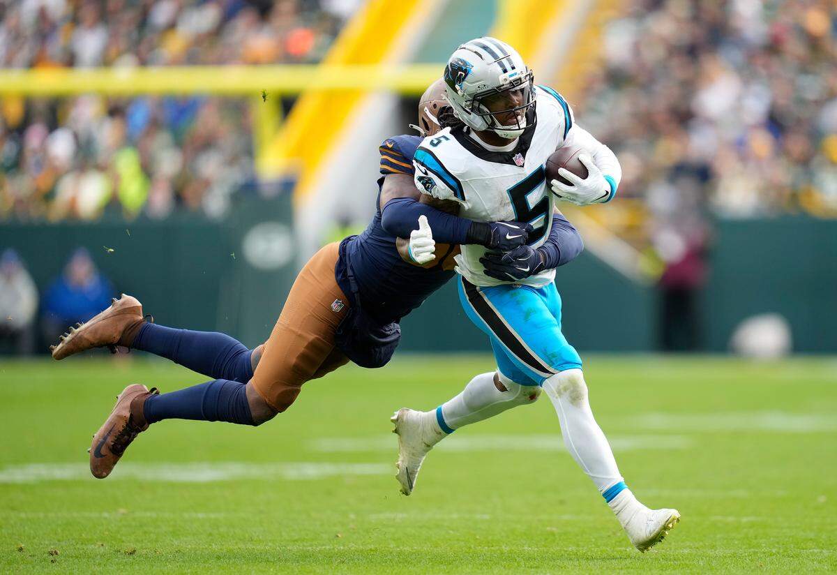 Rico Dowdle of the Carolina Panthers is tackled by Edgerrin Cooper of the Green Bay Packers during Sunday’s third quarter.