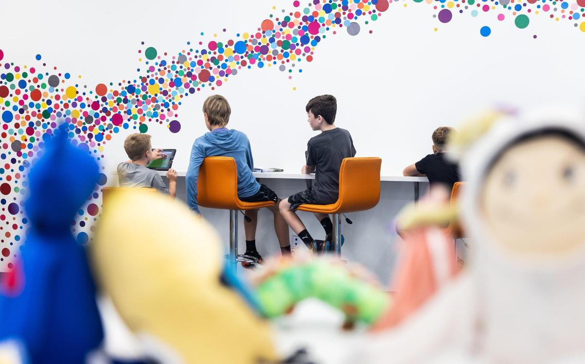Fourth grade students use iPads in the media center at Lake Norman Charter Elementary School in Huntersville, N.C., on Thursday, September 8, 2022.