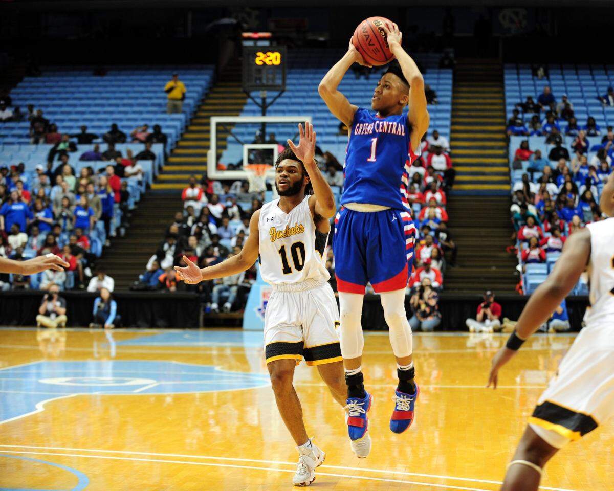 Greene Central’s DonQuez Davis (1) takes a jump shot as Forest Hills’ Jaleel McLaughlin (10) defends. The Greene Central Rams and the Forest Hills Yellow Jackets played the boys NCHSAA 2A basketball championship game in Chapel Hill on Saturday, March 10, 2018.