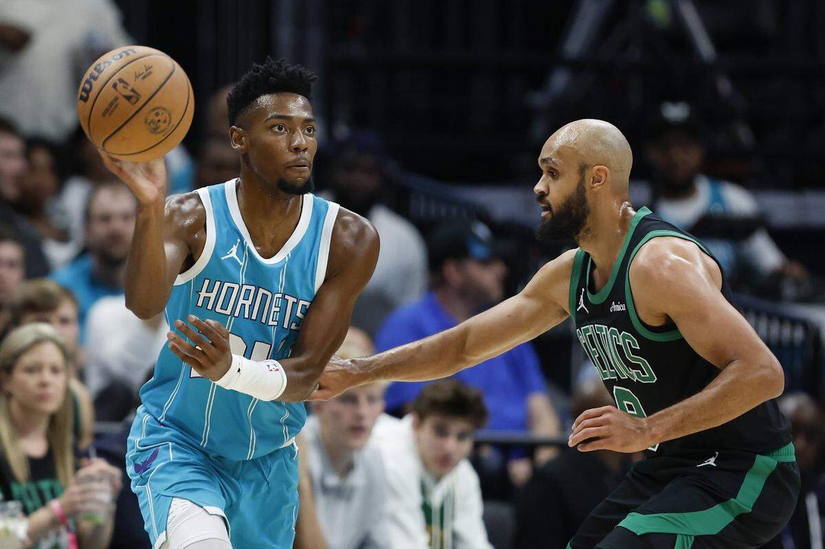 Charlotte Hornets forward Brandon Miller (24) passes the ball against Boston Celtics guard Derrick White (9) during the first quarter at Spectrum Center.