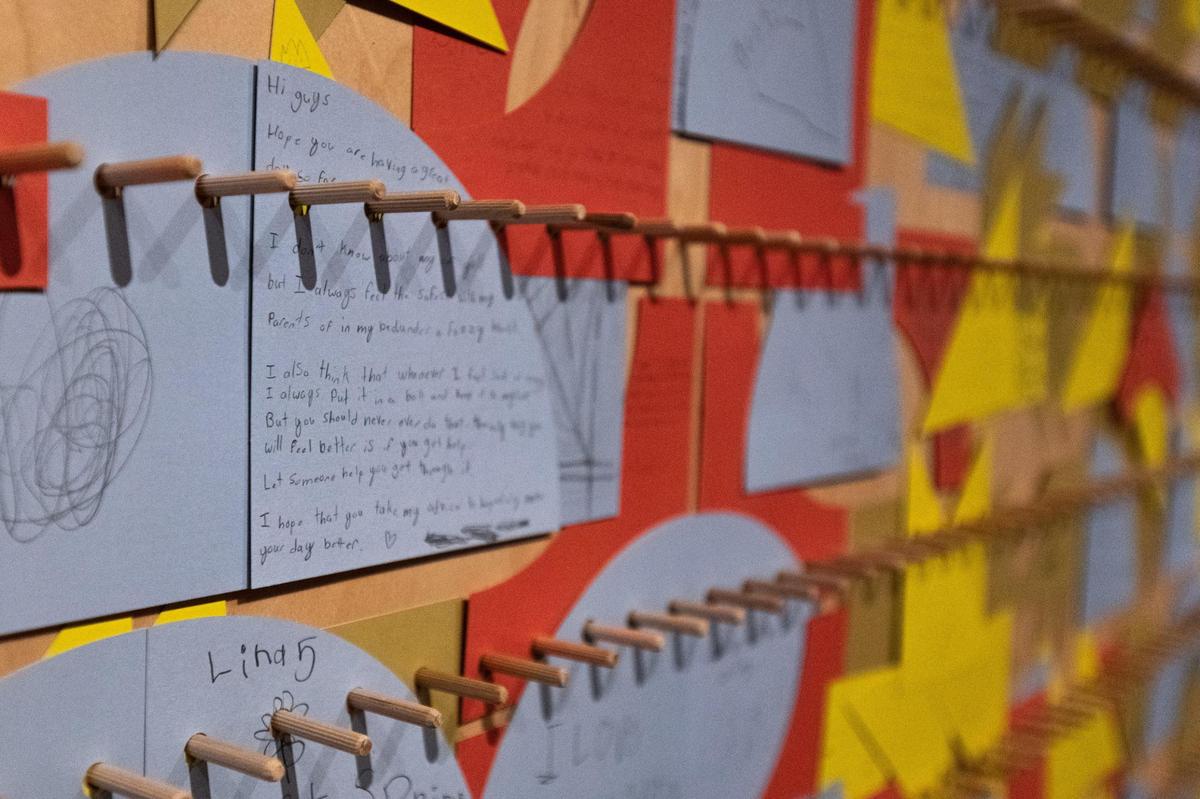 An interactive paper tapestry hangs on display in the Diedrick Brackens: ark of bulrushes exhibit.