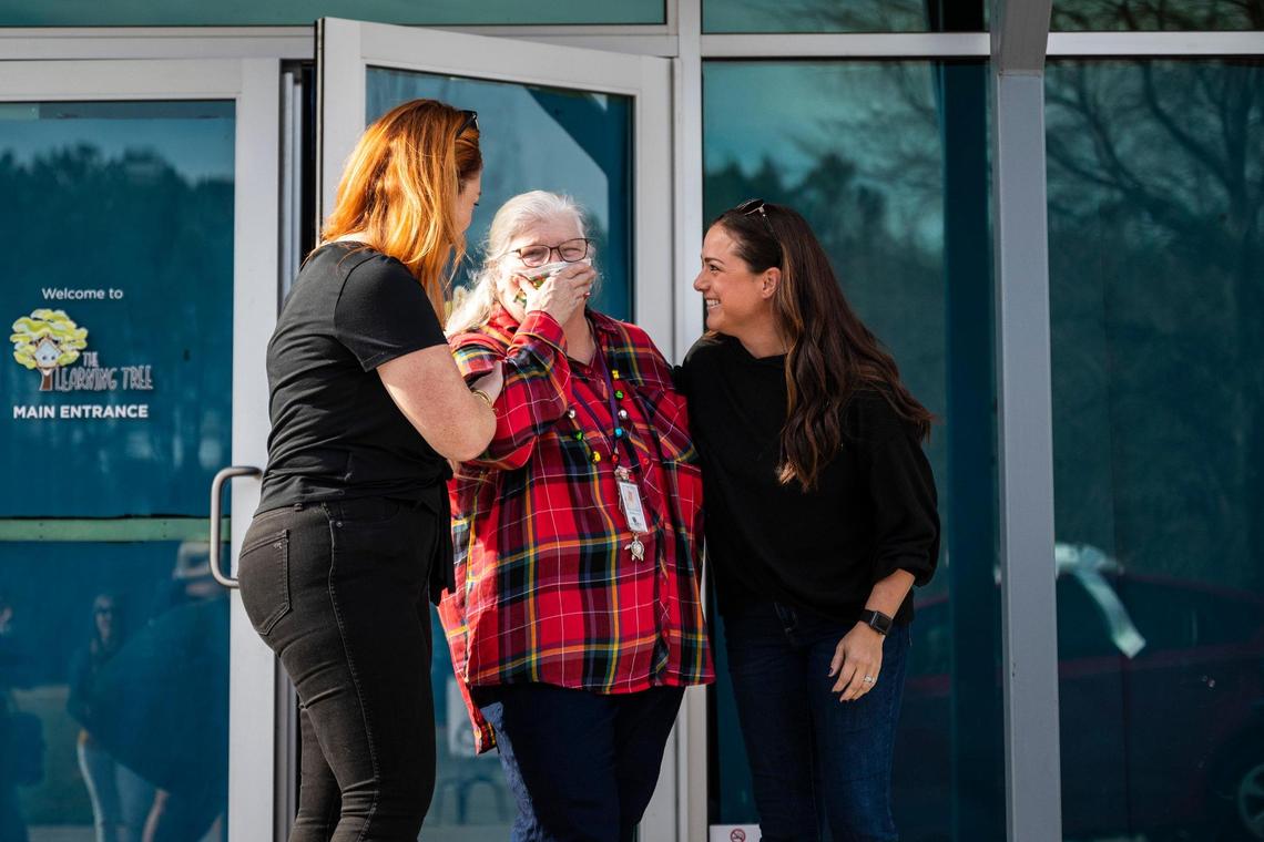 Debbie Arias, center, a preschool teacher at The Learning Tree at Lake Forest Church, reacts as she is surprised with a new Toyota Prius on Friday, December 17, 2021 in Huntersville. After learning that her minivan needed thousands of dollars worth of repairs, a parent, Whitnie Sharp, started a Go Fund Me campaign to get her the money to fix it. After receiving more money than expected from fellow parents and members of the church, the Mike Johnson Hickory Toyota dealership in Hickory caught wind of the efforts and decided to gift her a “new” used car.