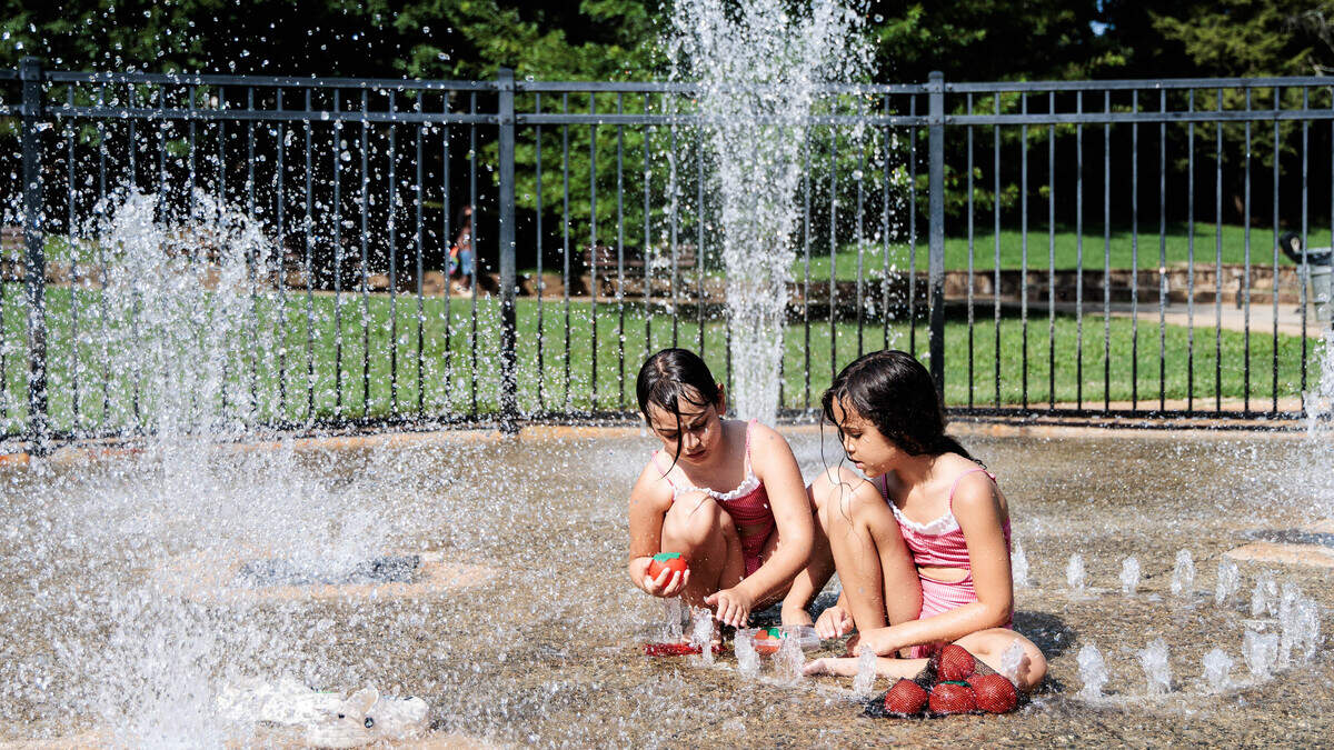Layla Harkey, 7, (left) and Liz Menezes, 8, cool off at Latta Park on Wednesday, July 1, 2026.