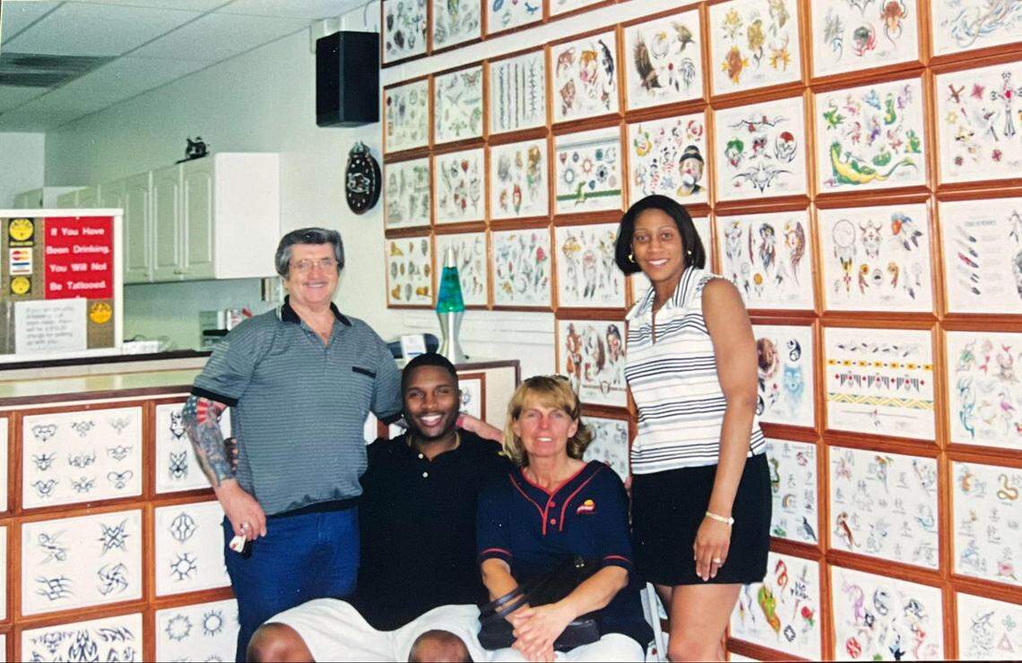 William “Bill” Thigpen and wife, Sandra, pose with customers in the early days of Tattoo Bill’s. Notice the lava lamp? This was the late ‘90s early 2000s, afterall.