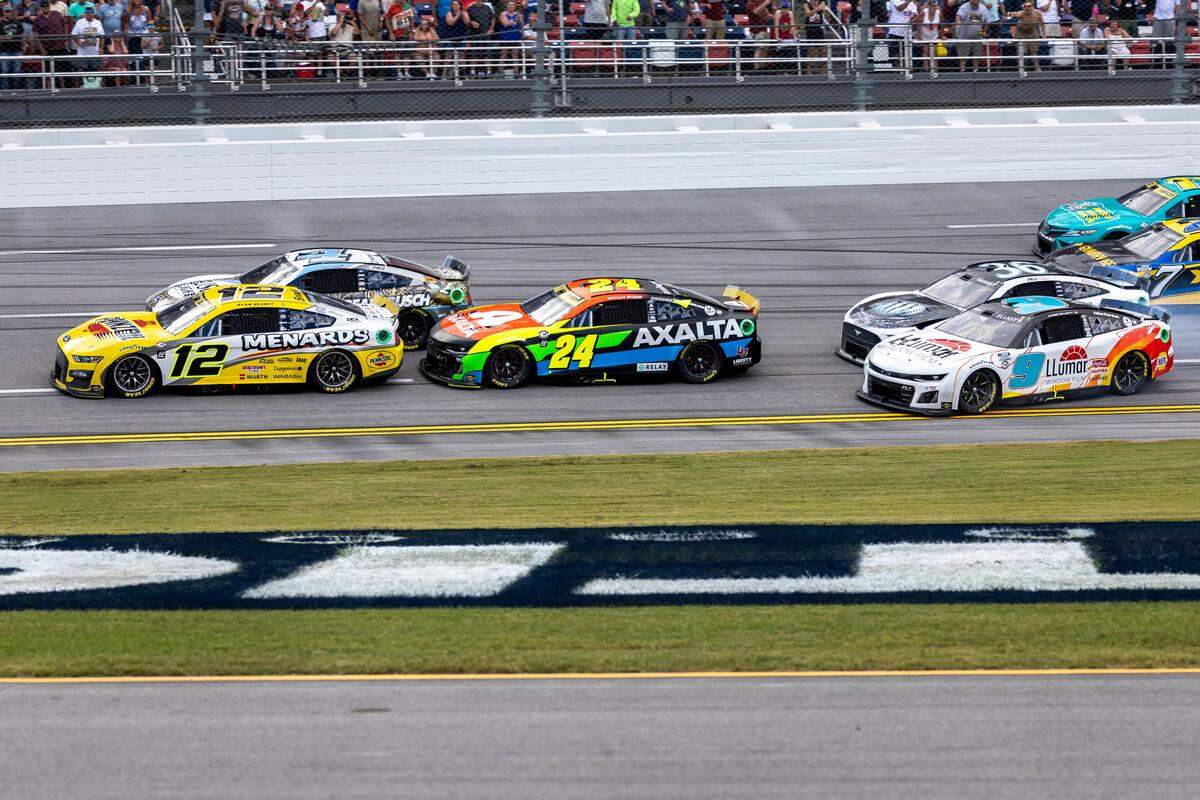 Oct 1, 2023; Talladega, Alabama, USA; NASCAR Cup Series driver Ryan Blaney (12) leads the final lap and wins the 2023 YellaWood 500 at Talladega Superspeedway. Mandatory Credit: Vasha Hunt-USA TODAY Sports