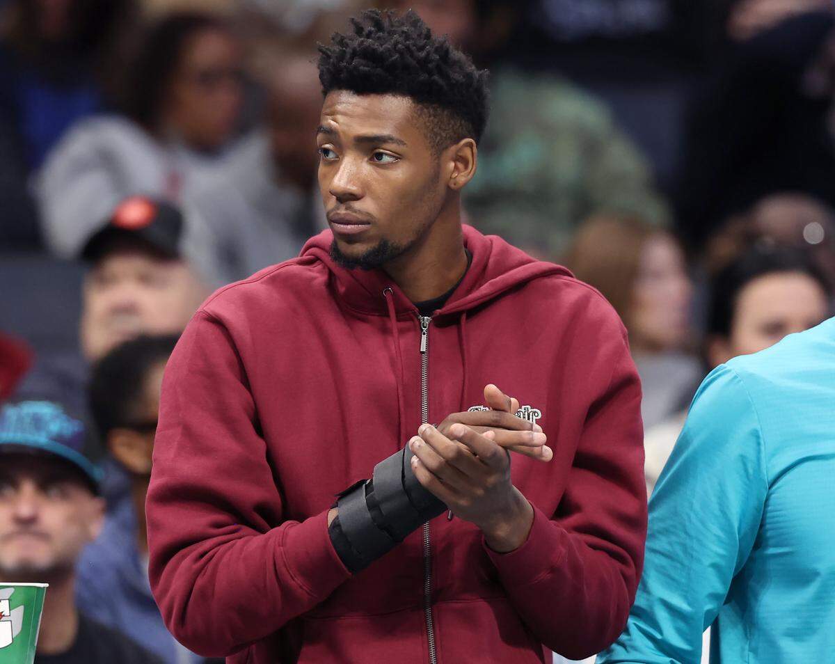 Injured Charlotte Hornets forward Brandon Miller stands along the team’s sideline during the team’s game against the Dallas Mavericks at Spectrum Center in Charlotte, NC on Monday, January 20, 2025.