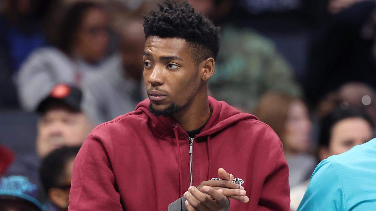 Injured Charlotte Hornets forward Brandon Miller stands along the team’s sideline during the team’s game against the Dallas Mavericks at Spectrum Center in Charlotte, NC on Monday, January 20, 2025.