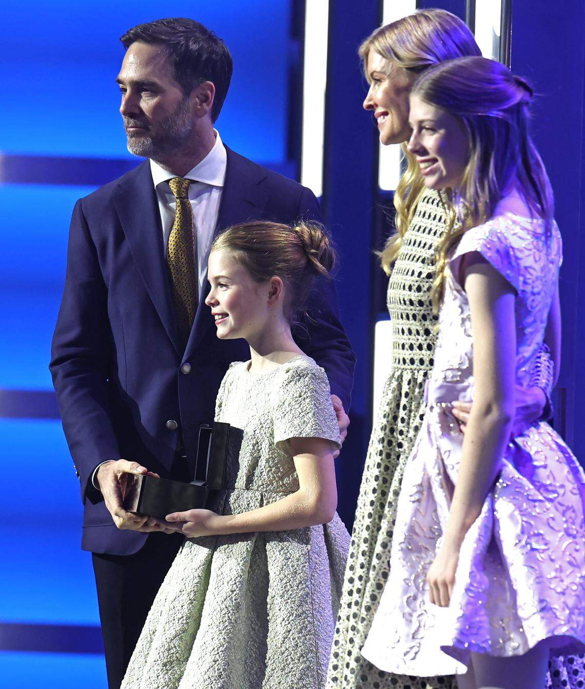 NASCAR Hall of Fame member Jimmie Johnson, left, receives his Hall of Fame ring as his daughter, Lydia, wife, Chandra Janway and daughter, Genevieve, look on prior to his induction ceremony speech on Friday, January 19, 2024 in Charlotte, NC.
