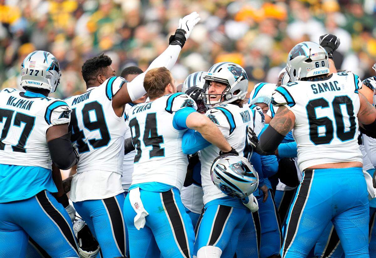 Members of the Carolina Panthers celebrate Sunday’s win against the Green Bay Packers. 