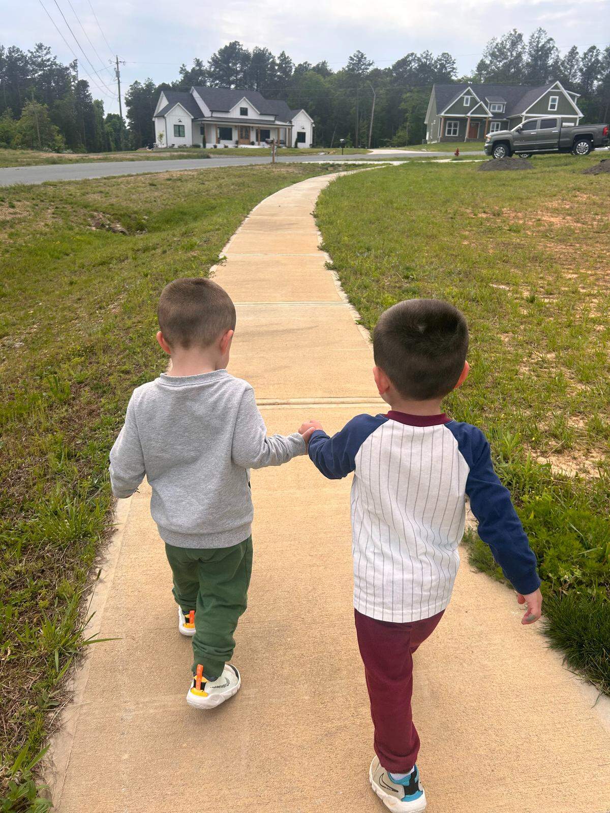 Logan and RJ walk near the Reeses’ home in Richfield, in a photograph taken before he was paralyzed.