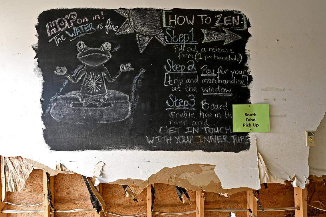Despite damaged drywall from the floodwaters of Hurricane Helene, a chalked instruction board remains inside Zen Tubing in Asheville, NC on Wednesday, February 5, 2025.