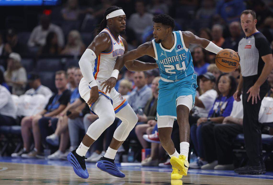 Charlotte Hornets forward Brandon Miller moves the ball down the court as Oklahoma City Thunder guard Luguentz Dort defends during the second quarter of a game between the Charlotte Hornets and the Oklahoma City Thunder at Paycom Center. 