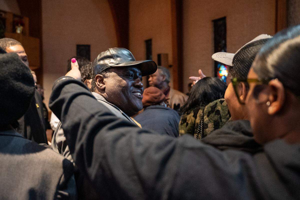 Bernard Robinson, center, receives hugs after a rally for his daughter, Shaquilla Robinson, who died under suspicious circumstances while on vacation in Mexico with friends in October.