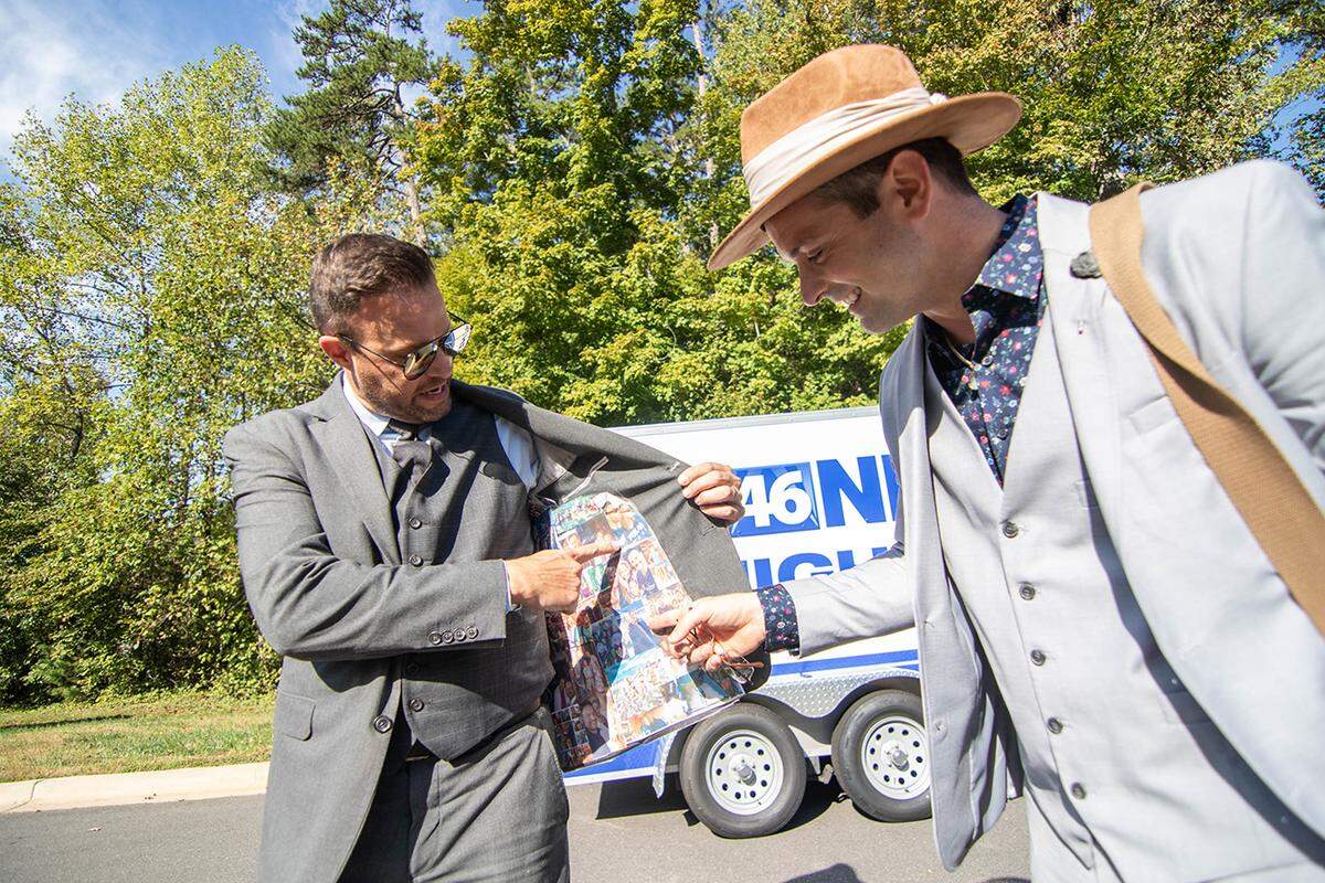 Fox 46’s Nick Kosir and Jason Harper, pointing at a photo of themselves inside of Harper’s jacket.