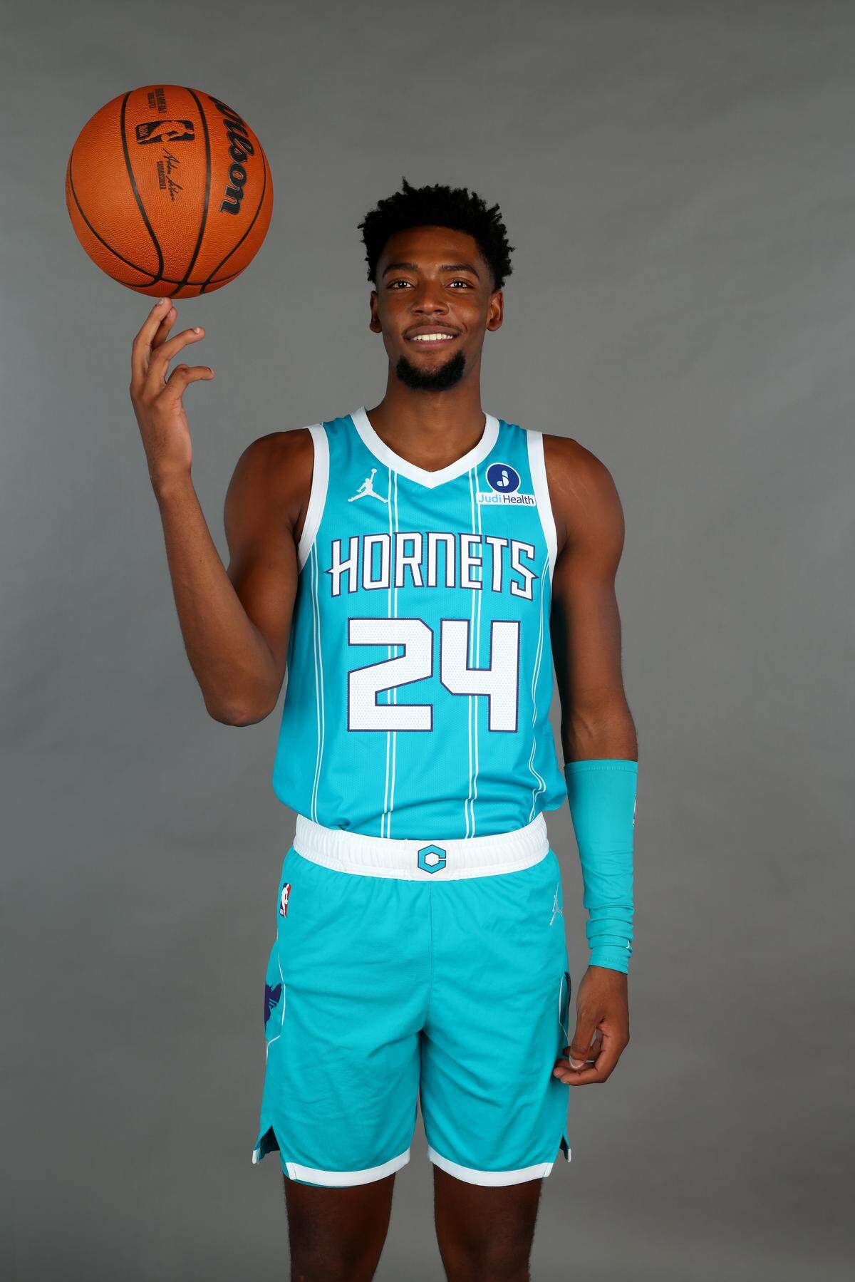 Brandon Miller models a Charlotte Hornets jersey.