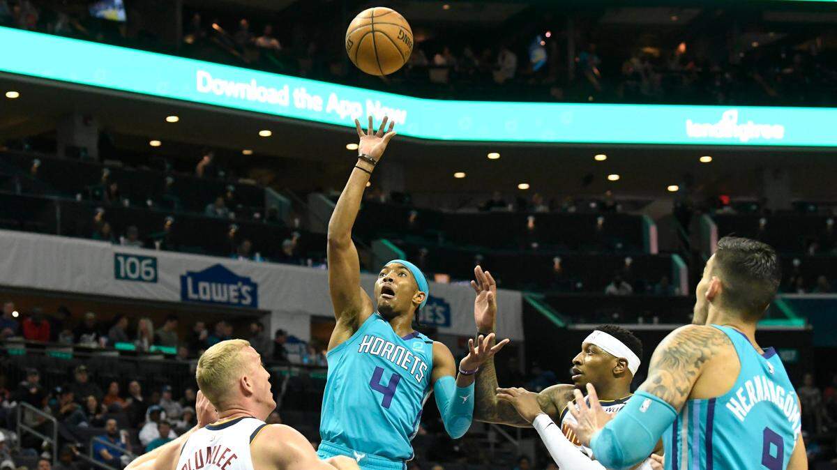 Charlotte Hornets guard Devonte’ Graham (4) floats a shot over Denver Nuggets forward Mason Plumlee (7) in the first half at the Spectrum Center in Charlotte, NC on Thursday, March 5, 2020. Denver led, 60-51, at halftime.
