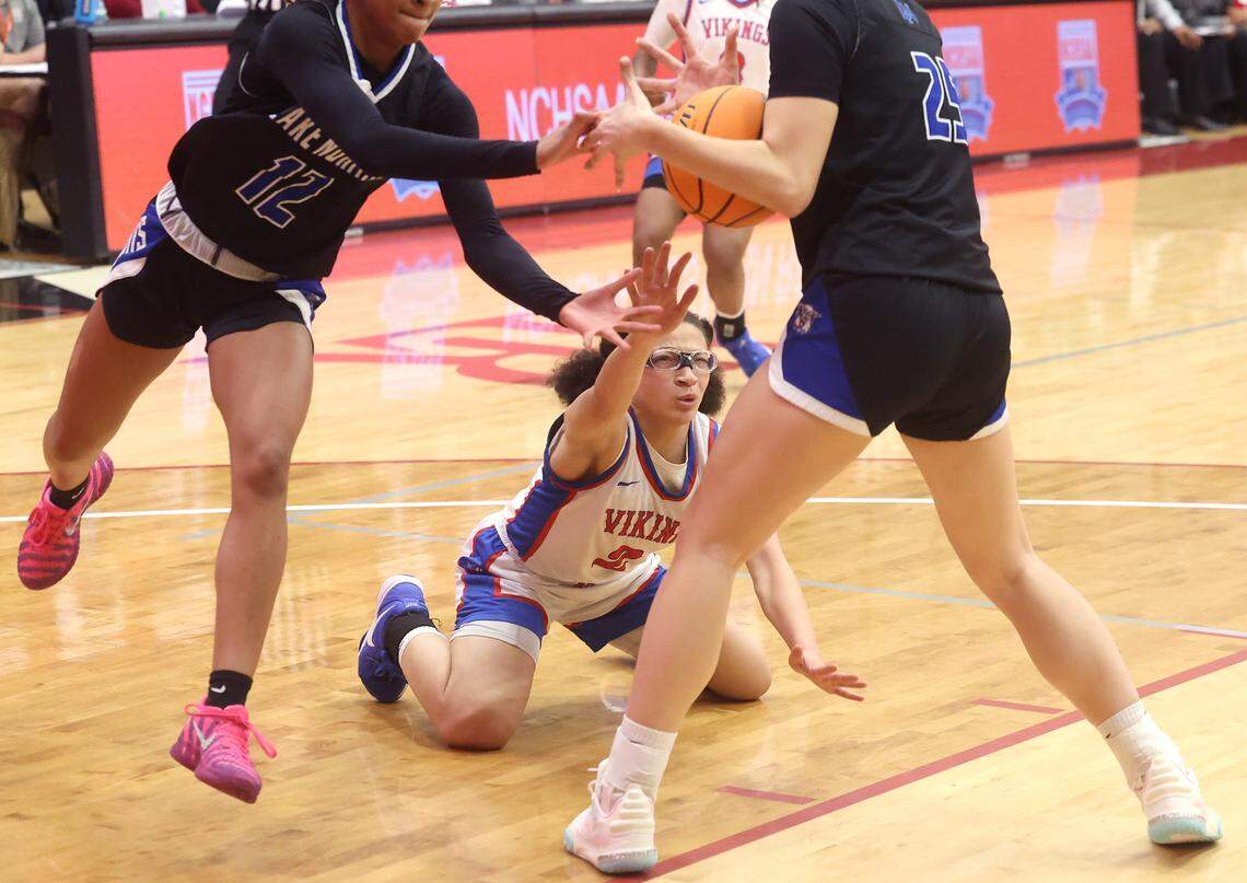 North Meck’s Stephanie Mobley, center, continues to fight to get a hand on the ball as Lake Norman’s Rayana Minard, left and Jeta North secure the ball during the 7A Girls NCHSAA regional championship game at Lenoir-Rhyne University in Hickory, North Carolina, on Friday, March 6, 2026.