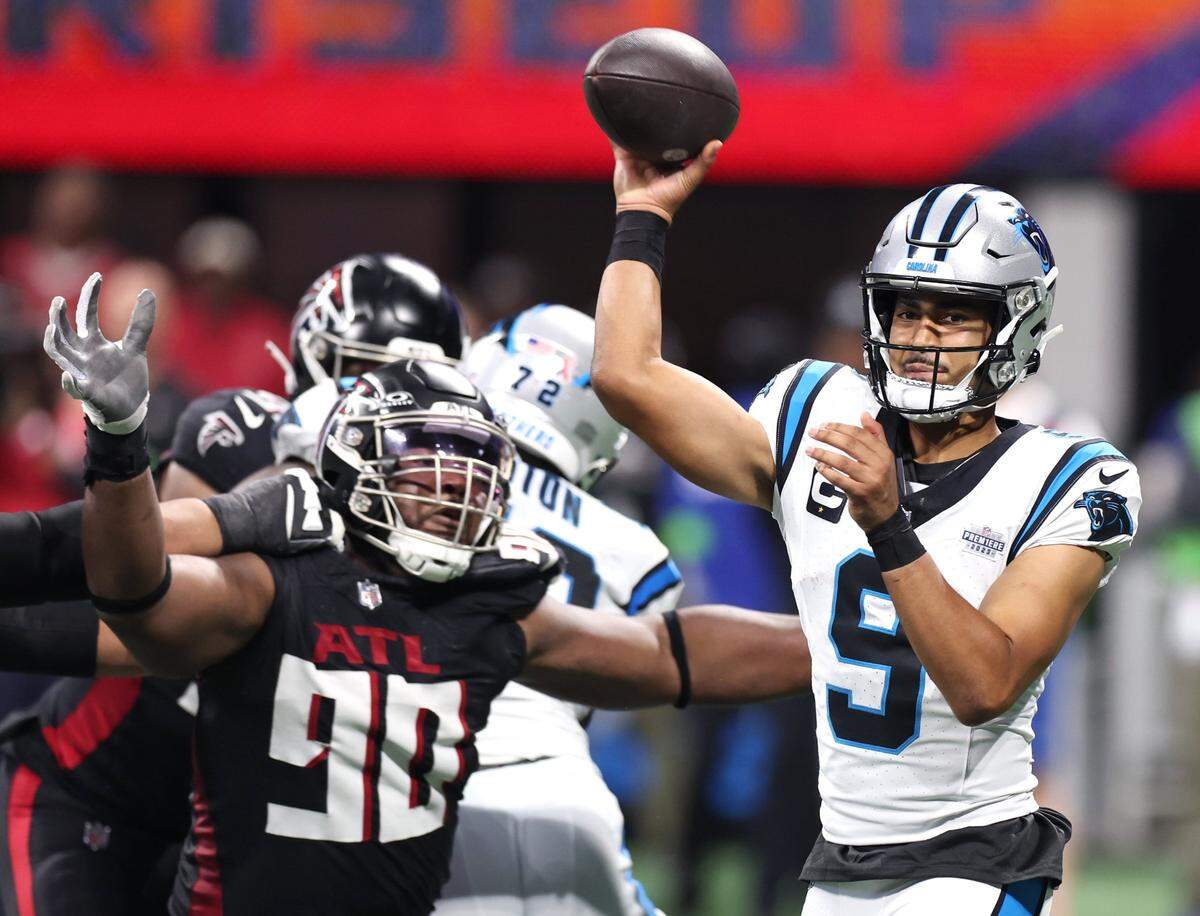 Carolina Panthers quarterback Bryce Young passes to a receiver as the Atlanta Falcons defense rushes during fourth-quarter at Mercedes-Benz Stadium in Atlanta, GA on Sunday, September 10, 2023. The Falcons defeated the Panthers 24-10.
