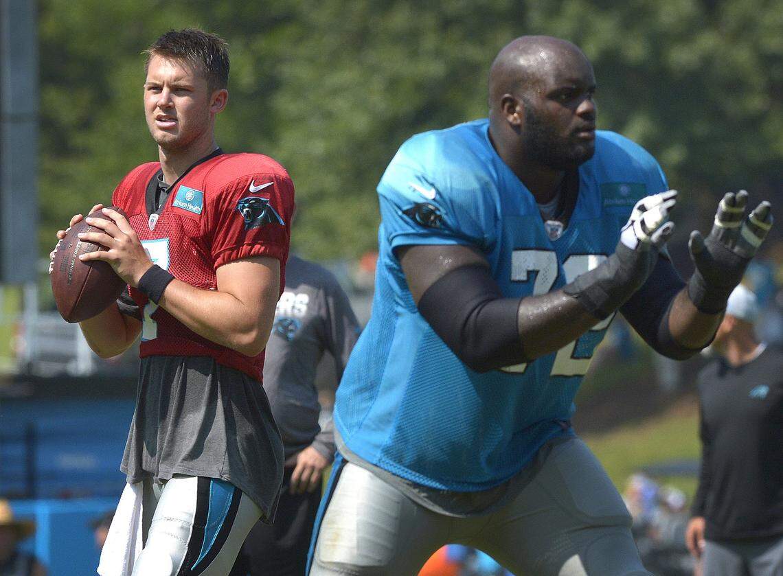 Carolina Panthers quarterback Kyle Allen and offensive lineman Taylor Moton run through a passing drill during practice on Thursday.
