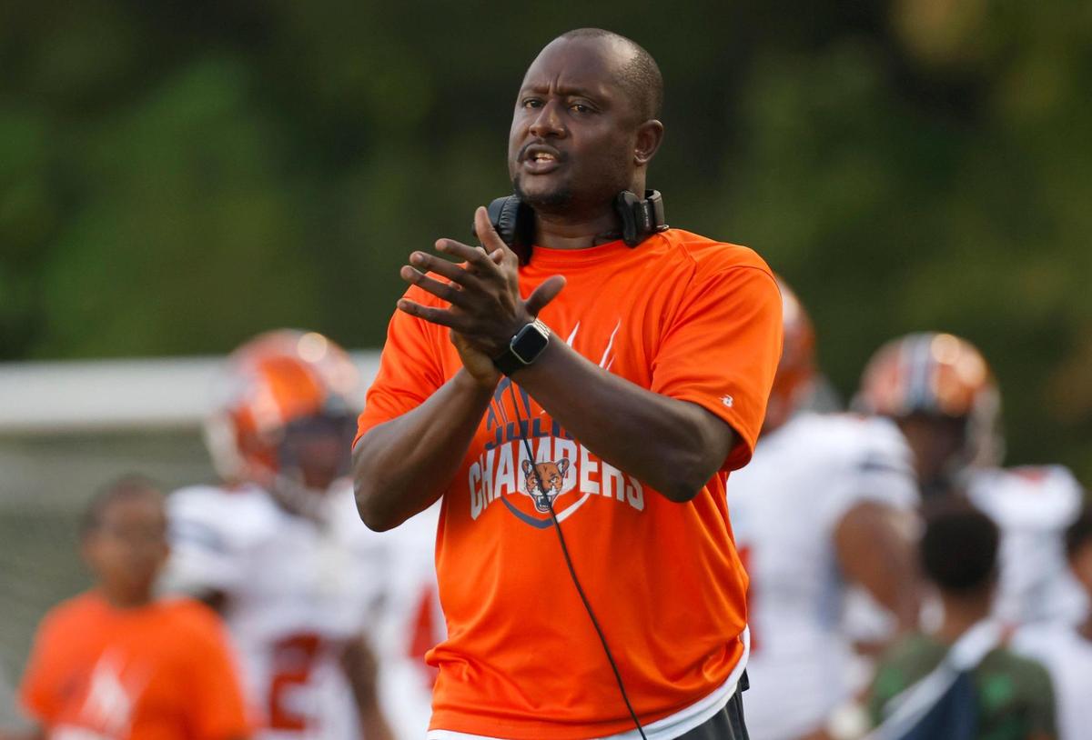 Julius Chambers head coach Montis Lash applauds his player after taking a lead in the first quarter against Cardinal Gibbons on Friday, August 29, 2021 in Raleigh, N.C.