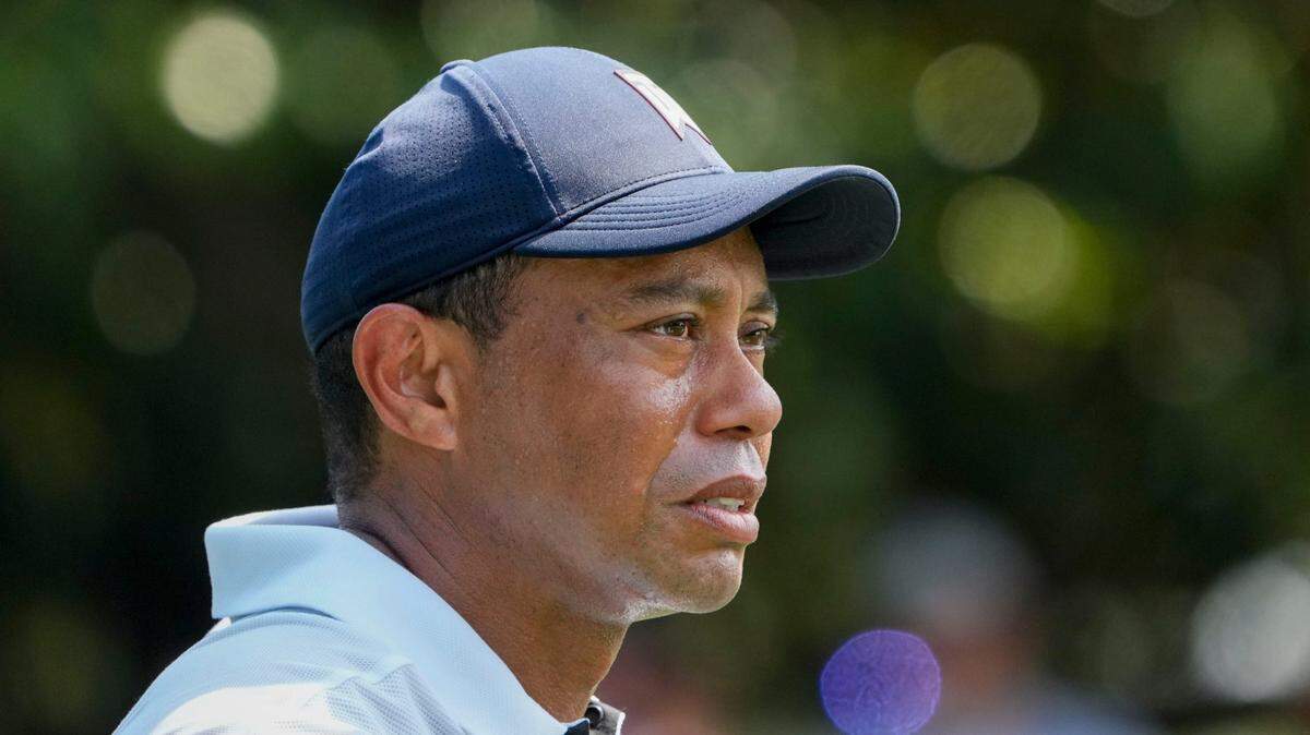 Tiger Woods stands at the eighth green Thursday during the first round of The Masters golf tournament.