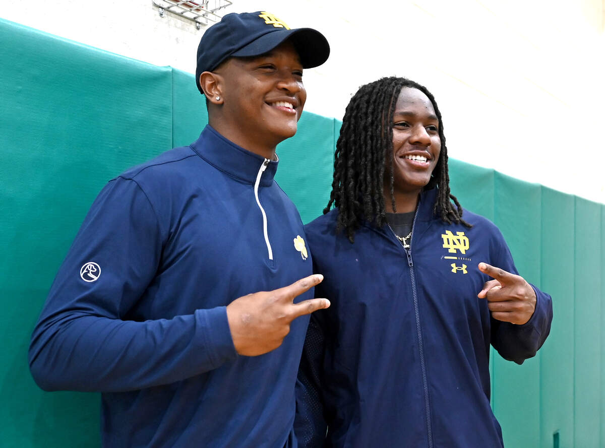 Myers Park’s Rodney Dunham, left, poses for photographs with fellow Notre Dame commit and Weddington High football standout Thomas Davis Jr., right, following Dunham’s announcement that he will be attending Notre Dame. Dunham a Top 10 national football recruit had narrowed down his choices to Duke, South Carolina, Georgia, Tennessee and Notre Dame.