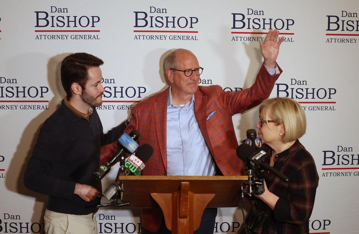 Congressman Dan Bishop, center, waves to his supporters as he concedes the race for the NC Attorney General to Jeff Jackson on Tuesday, November 5, 2024. At left is Bishop’s son, Jack and at right is his wife, Jo Bishop.