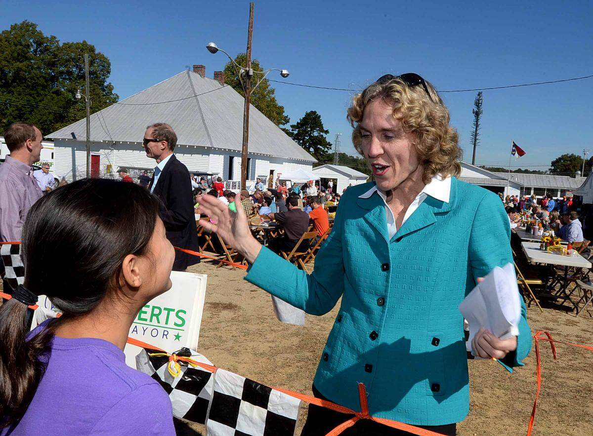 Democratic Mayoral candidate Jennifer Roberts greets Kara Parker, 11, left, at the annual Mallard Creek BBQ event at Mallard Creek Presbyterian Church Oct. 22, 2015 