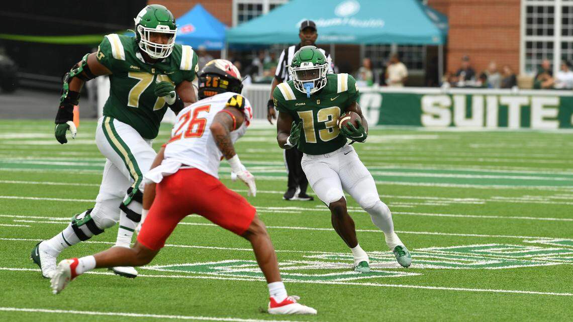 Charlotte 49ers running back Shadrick Byrn (13) carries the ball as University of Maryland’s Gavin Gibson (26) goes for the tackle during their game in Charlotte, NC, on Saturday, Sept. 10, 2022.