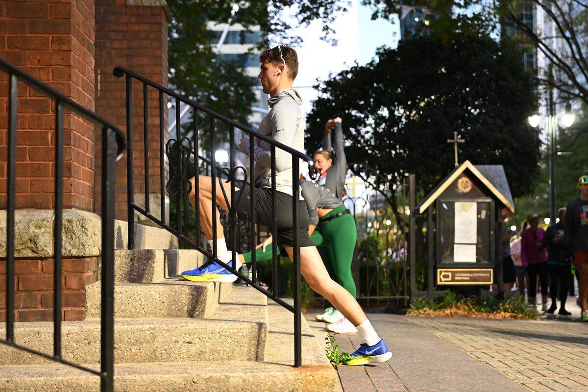 Participants stretch prior to taking part in the 20th annual Novant Health Charlotte Marathon on Saturday, Nov. 16, 2024, in Charlotte