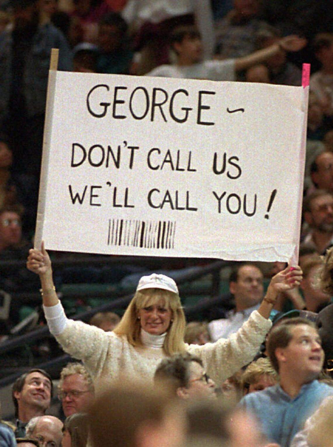 In 1996, a Charlotte Hornets fan holds up a sign referencing team owner George Shinn.
