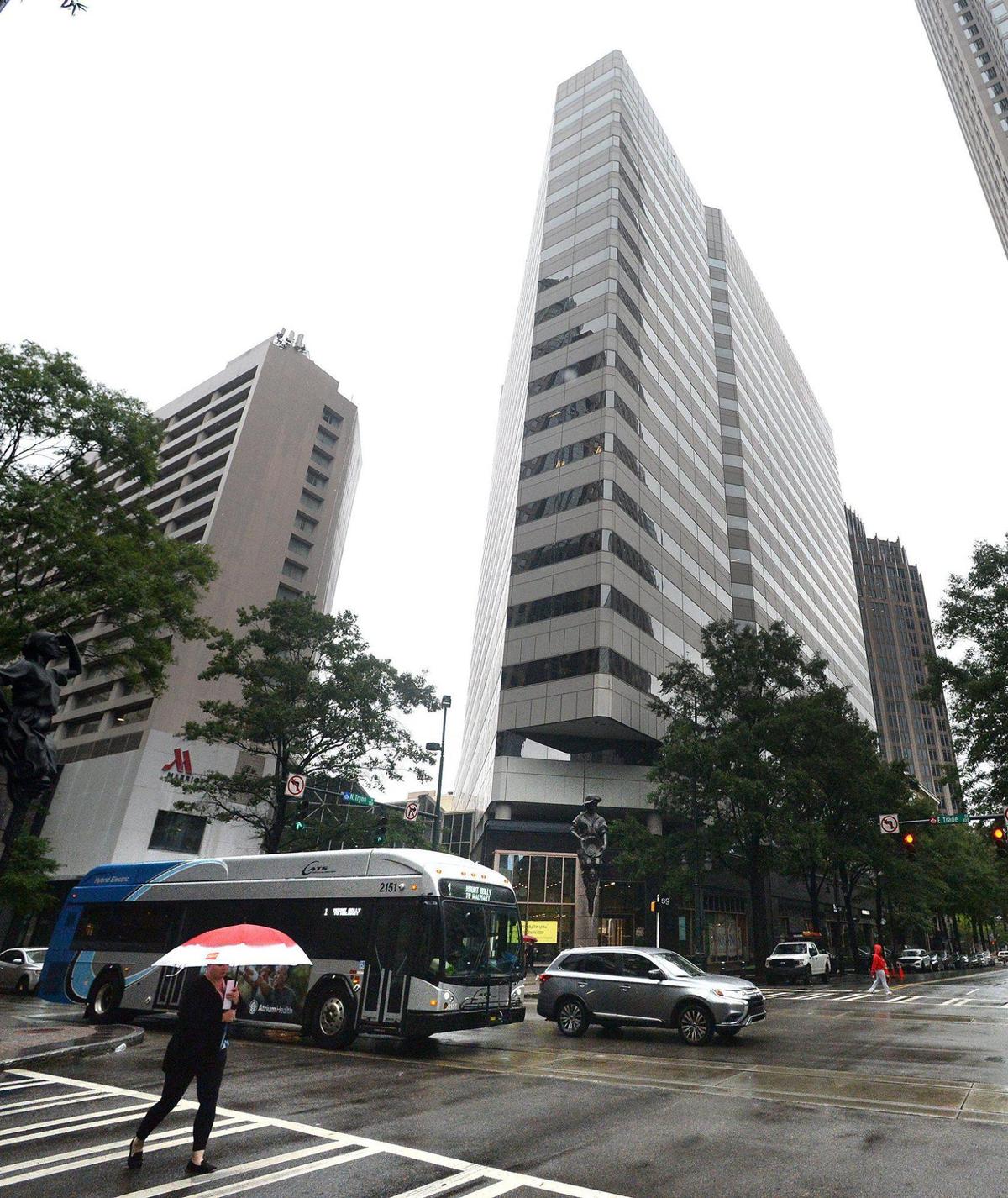 One Independence Center (right) rises above the Marriott Hotel next door in uptown Charlotte. It has been redesigned to entice people to come back to work, adding shops and other amenities to further encourage their return.