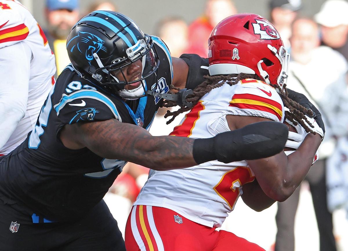 Carolina Panthers defensive end LaBryan Ray, left, reaches out to make the tackle on Kansas City Chiefs running back Kareem Hunt, right, during action on Nov. 24, 2024, at Bank of America Stadium. The Chiefs defeated the Panthers 30-27.
